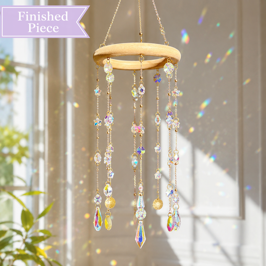 Aurora Halo finished crystal glass suncatcher hanging beside a sunny window with rainbow reflections.