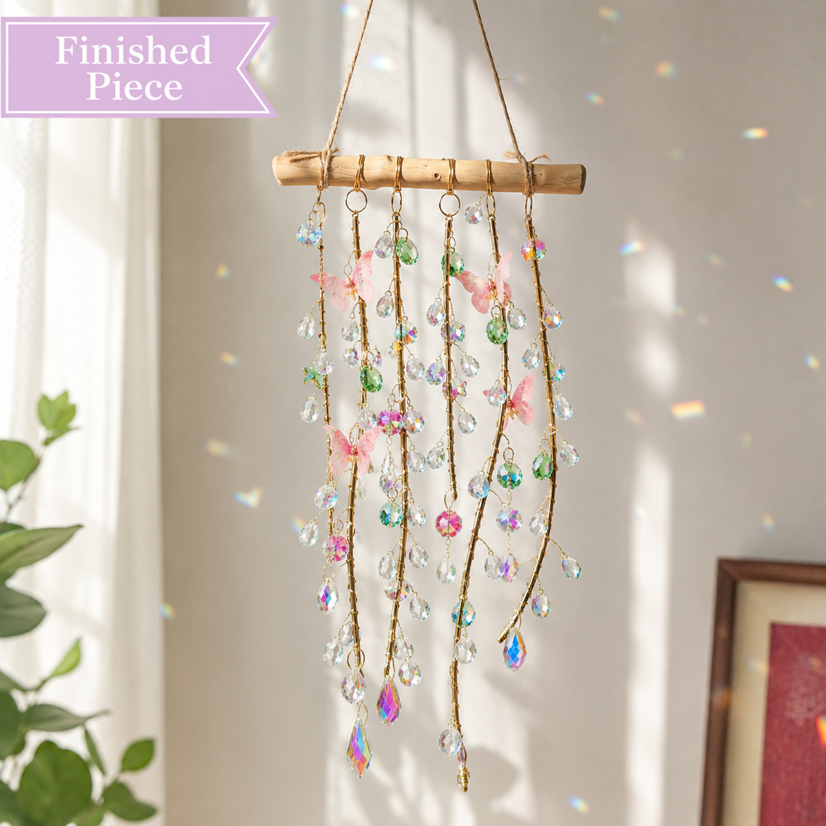 Butterfly Prism Willow finished suncatcher with pink, green, and clear crystal strands on natural wood.