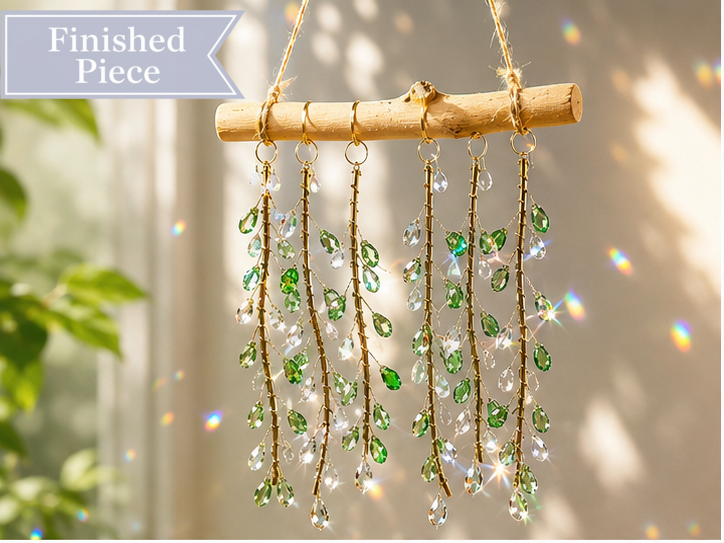Emerald Willow finished suncatcher with green faceted glass leaves and clear drops on natural driftwood.