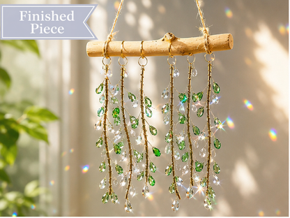 Emerald Willow finished suncatcher with green faceted glass leaves and clear drops on natural driftwood.