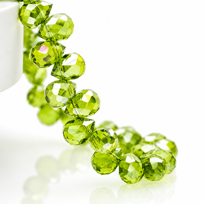 Close-up of Olive Green faceted teardrop glass beads