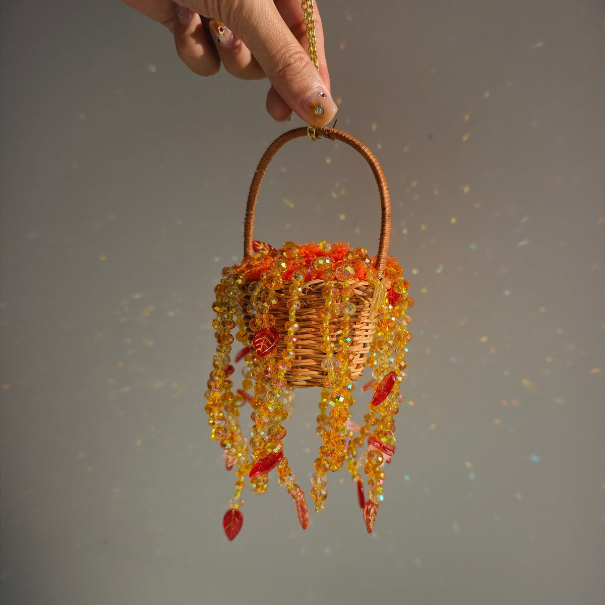 Handheld Autumn Dusk beaded hanging basket showing scale