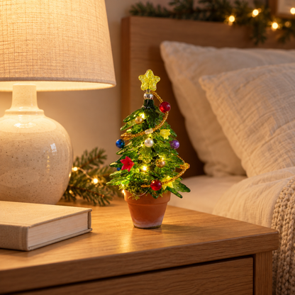 Small illuminated beaded Christmas tree on a cozy bedside table