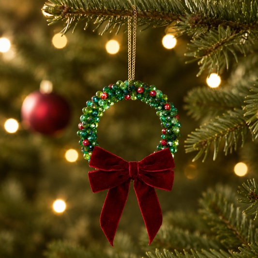 Green and red beaded Christmas wreath hanging as a tree ornament