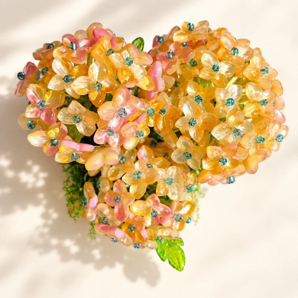 Close-up of pink and golden glass-bead hydrangea blooms