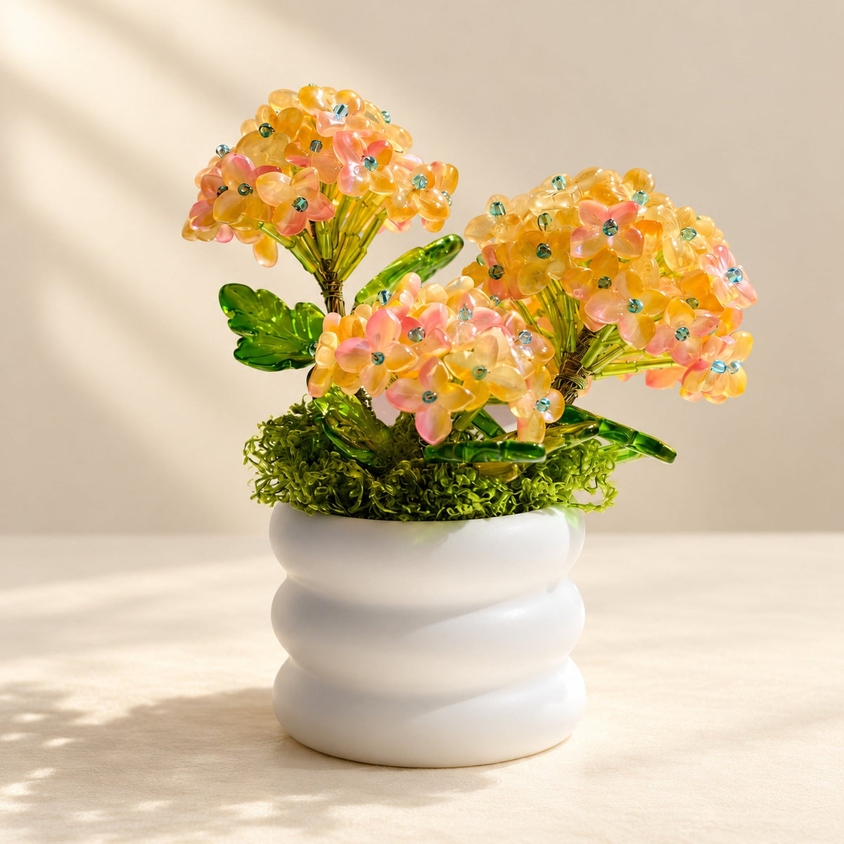 Beaded hydrangea tabletop arrangement in a white ceramic pot