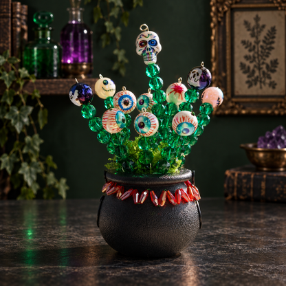 Halloween witch cauldron beaded plant in a dark green witch apothecary