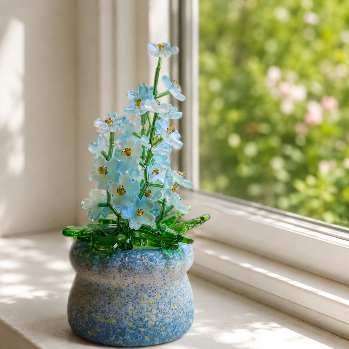Blue forget-me-not beaded plant sparkling on a bright garden windowsill