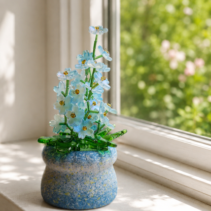 Blue forget-me-not beaded plant sparkling on a bright garden windowsill