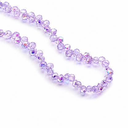 Two strands of faceted purple glass beads arranged on a white background