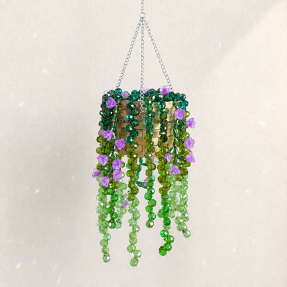 Cascading green beaded hanging plant with deep purple flower beads and a silver chain