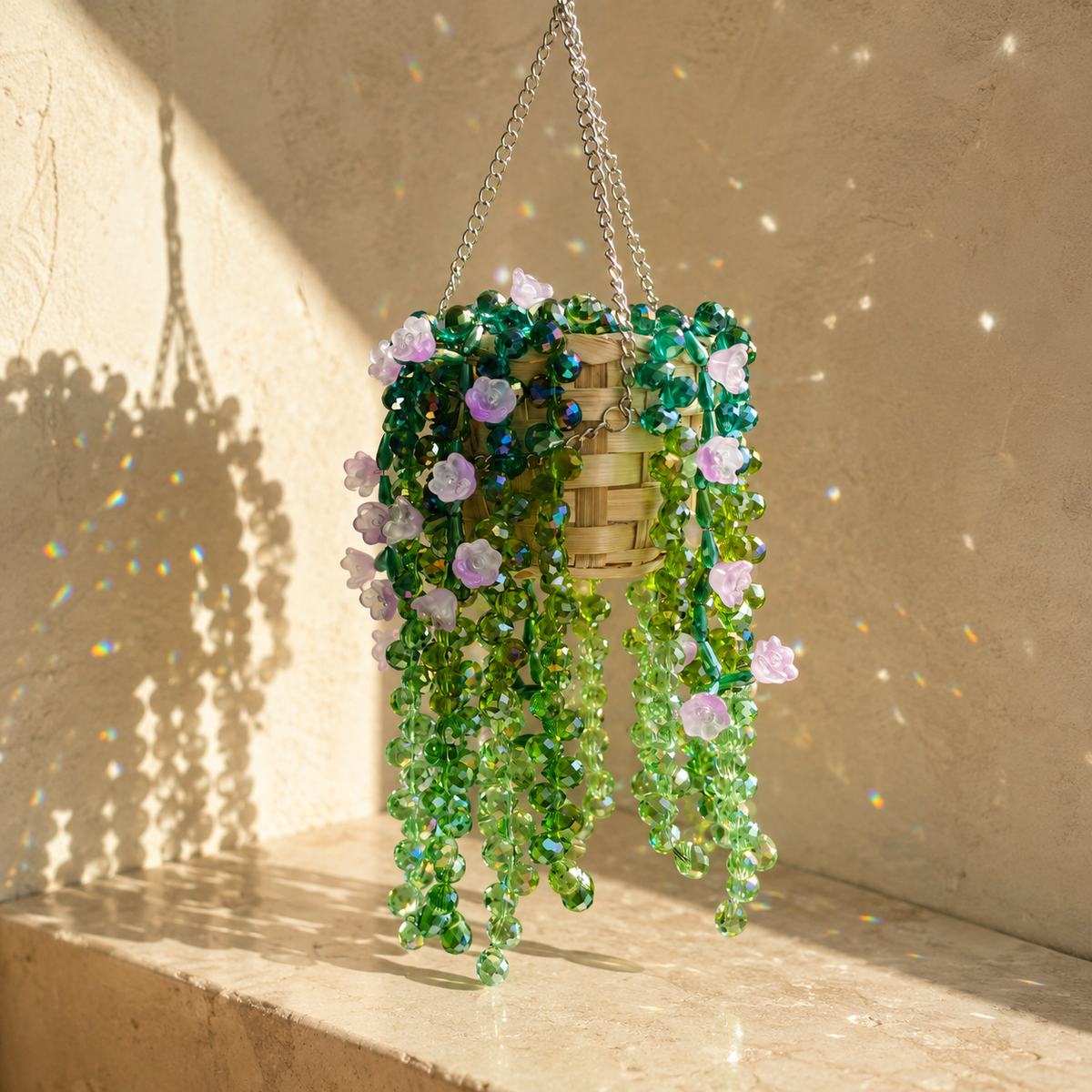 Cascading wisteria beaded hanging plant with green crystal beads and lavender flowers casting rainbow light spots