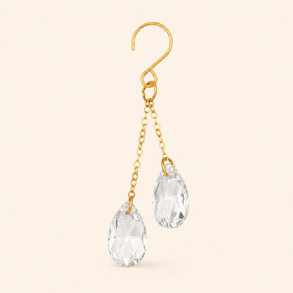 Close-up of one clear crystal plant vine charm with a gold-tone hook, two chains, and two faceted teardrop prisms.