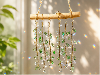 Emerald Willow finished suncatcher with green faceted glass leaves and clear drops on natural driftwood.