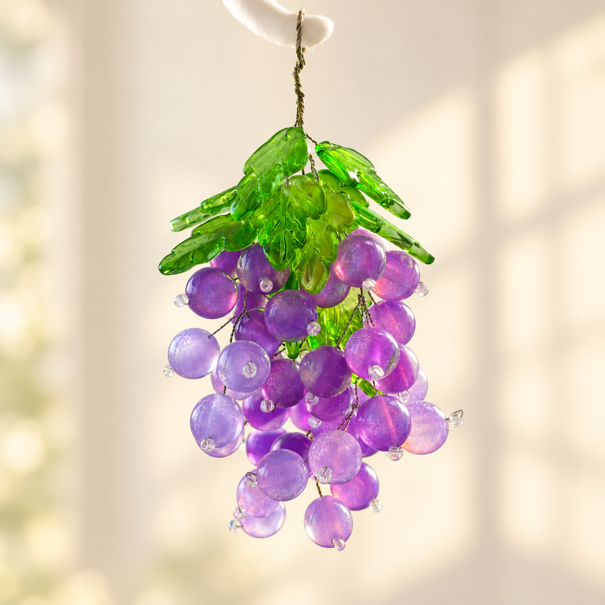 Purple grape beads and green leaf beads close-up