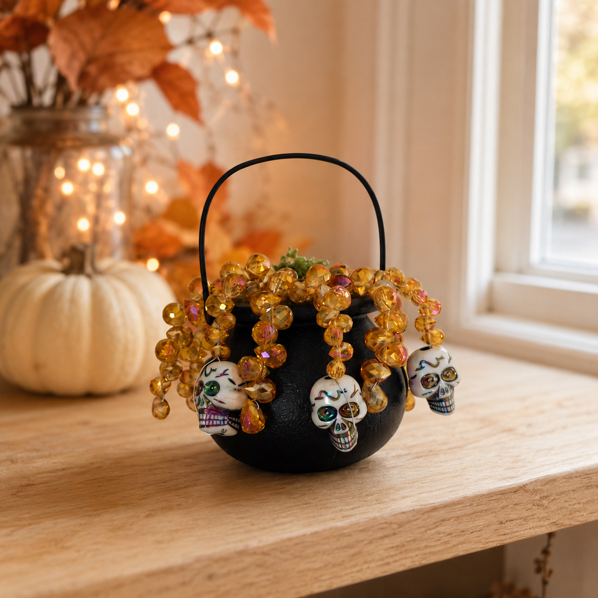 Halloween witch cauldron beaded plant displayed on an autumn shelf