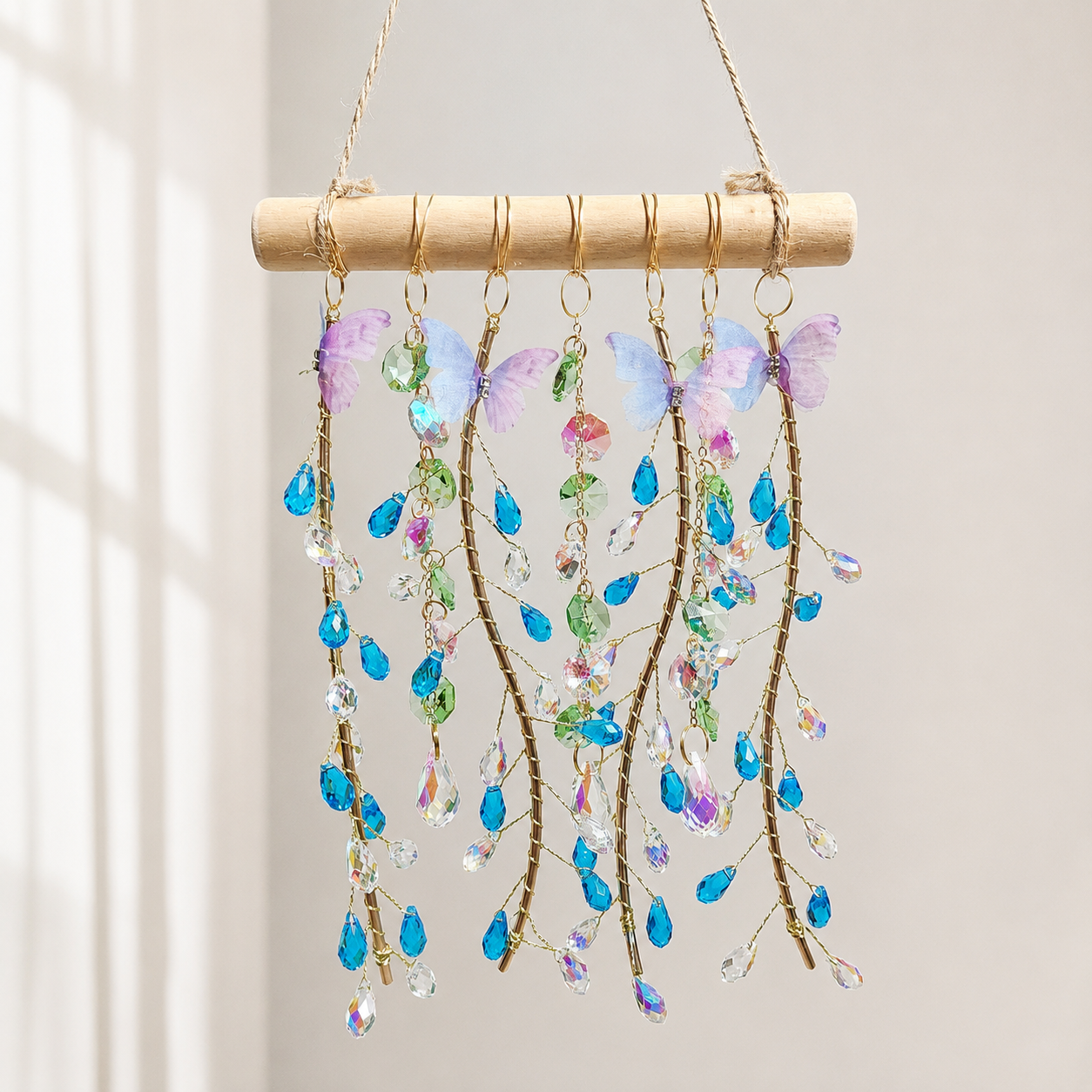 Ocean Willow finished suncatcher with blue teardrop crystals, pastel butterflies, and natural wood.