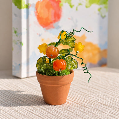 Mini pumpkin and yellow flower beaded plant in warm natural window light